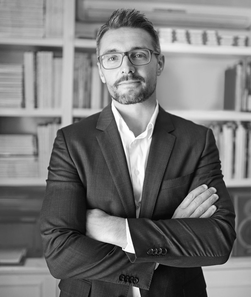 Ethan Brooks, Co-Founder and Head of Strategy (US) at Axis Web Art, standing with arms crossed in an office