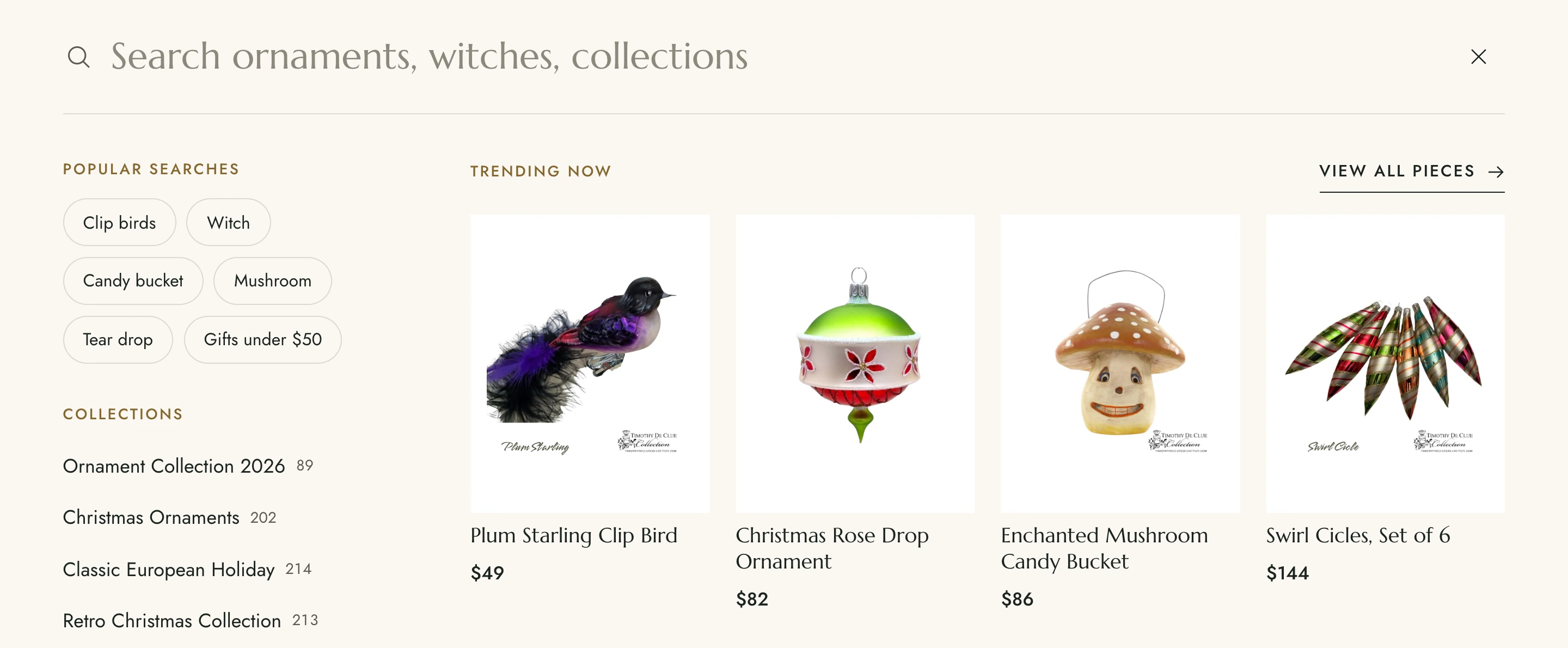 The search overlay: popular searches, collections with counts, and a trending row of ornaments.